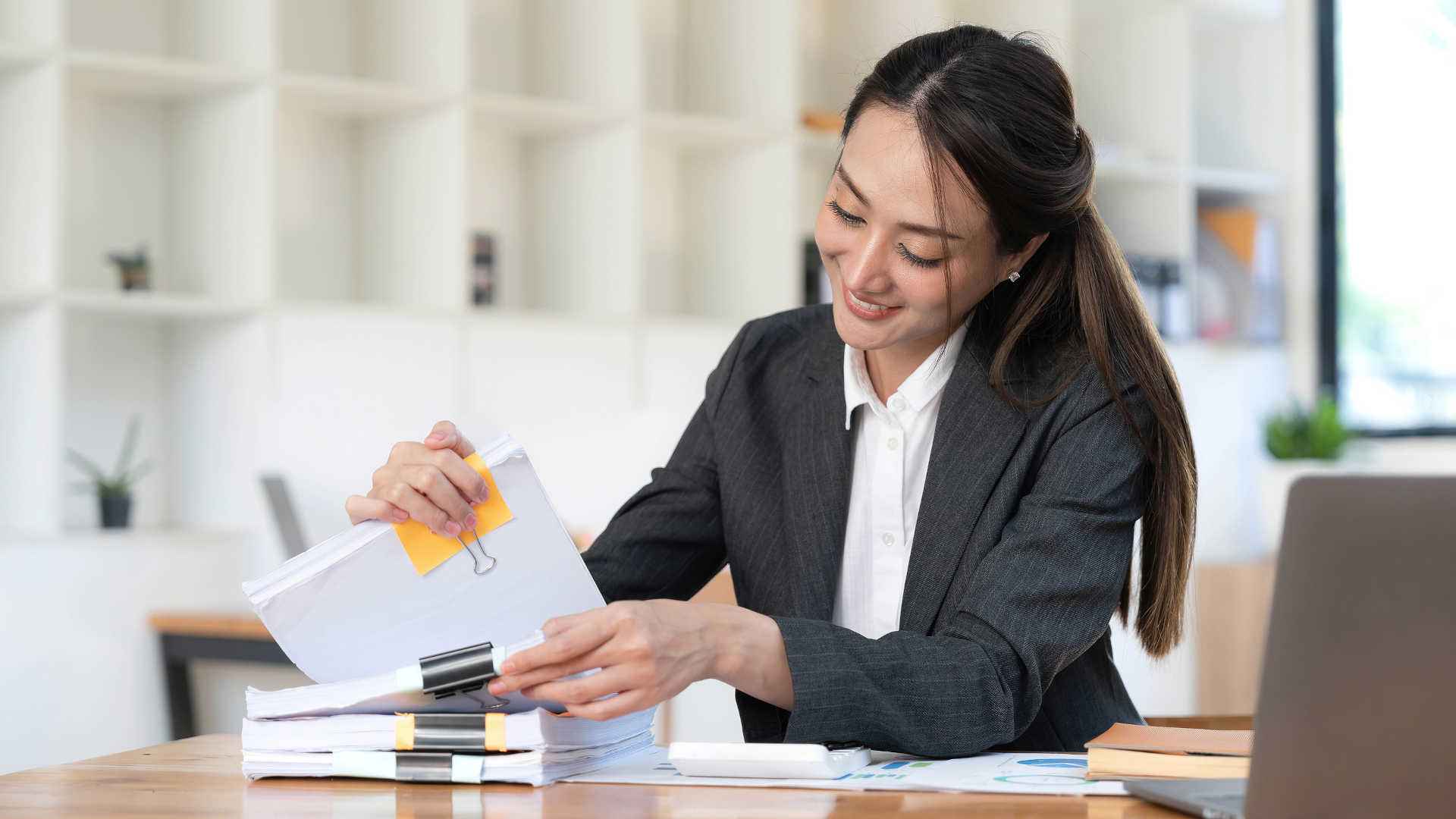 Document automation for law firms concept image - a female lawyer sorting through documents