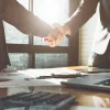 Shaking hands after business success from contract automation