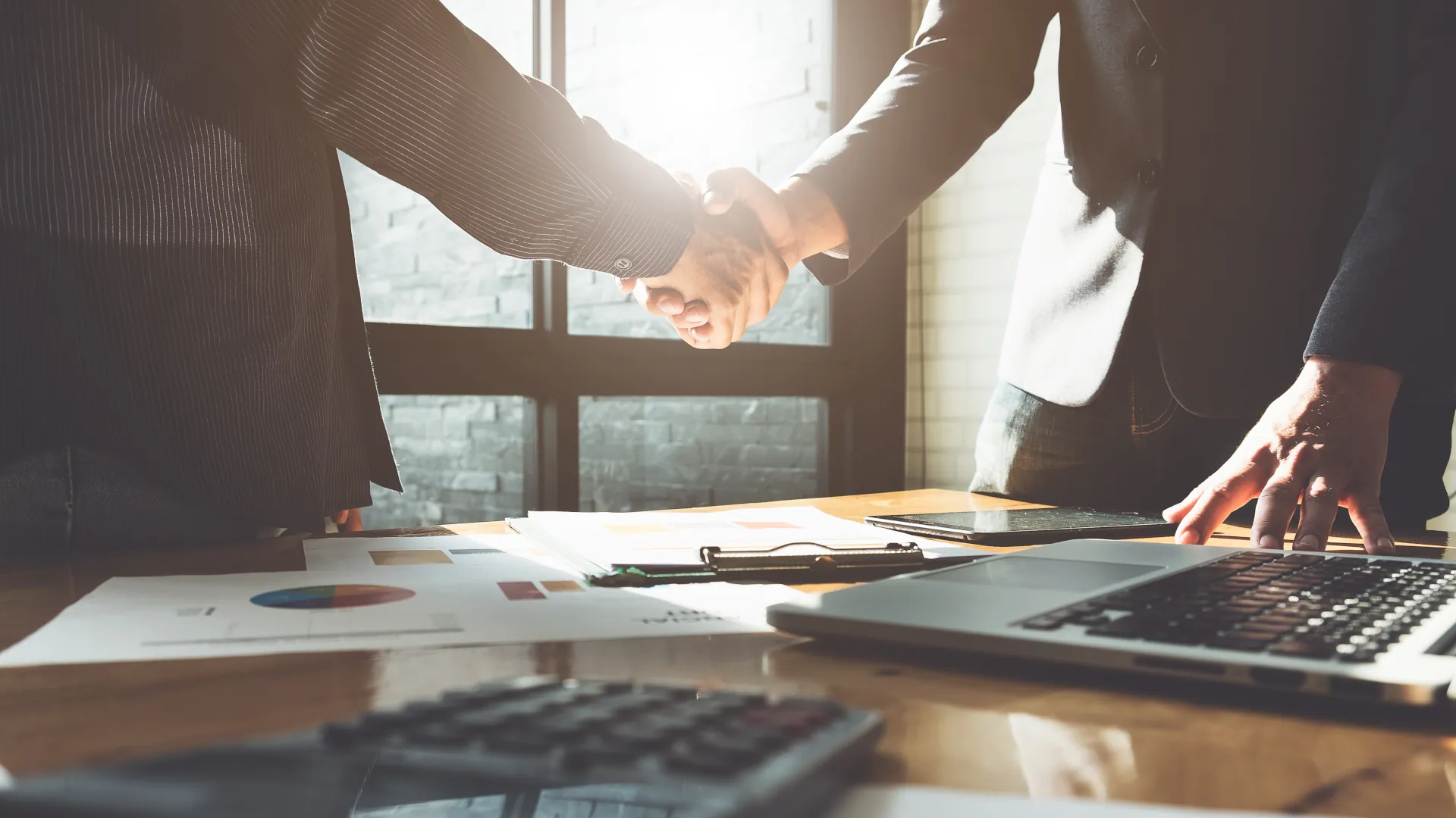 Shaking hands after business success from contract automation