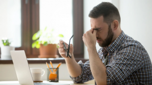 Man frustrated by traditional OCR at desk Filename: traditional-ocr-frustrations