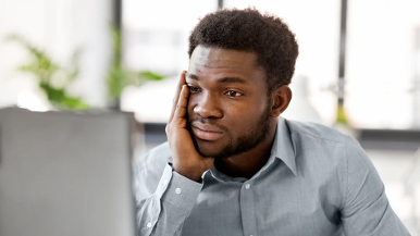 tressed finance team member in front of computer - automated invoice system