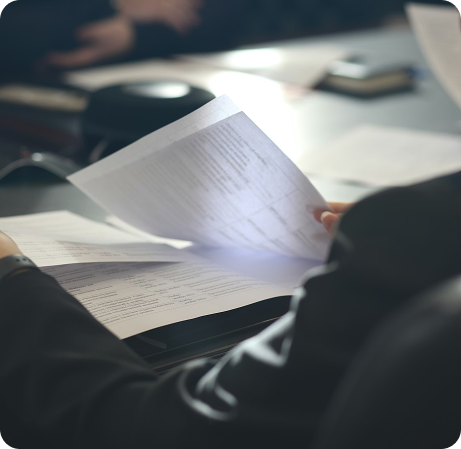View of documents over the shoulder of someone in a suit